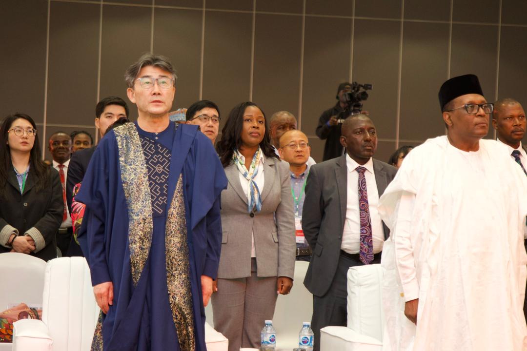 Prof. George F. Gao joins Nigerian delegates as both national anthems are observed at the opening of the Symposium, 30 March 2026.